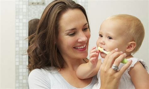Kūdikis valosi pirmuosius dantukus minkštu šepetėliu