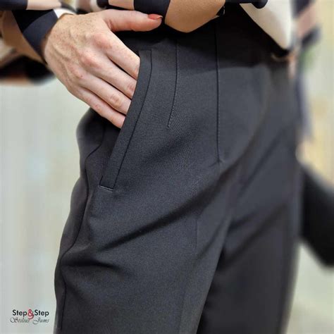 Moteris su pilvu matuojasi kelnes