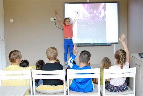 Vaikai žaidžia spalvingame darželio kieme