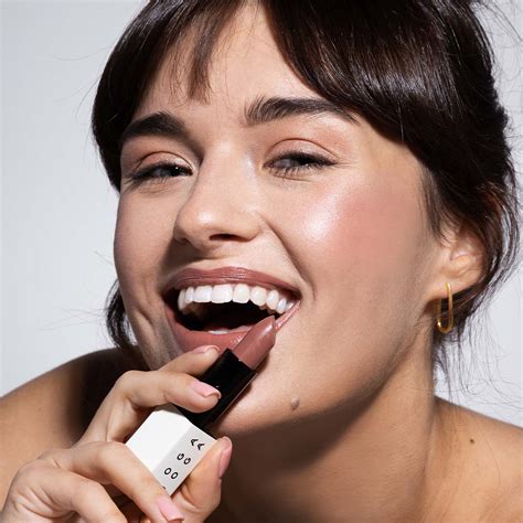 Moterys naudoja lūpų balzamą ir kremą