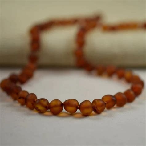 Gintariniai karoliai kūdikiams