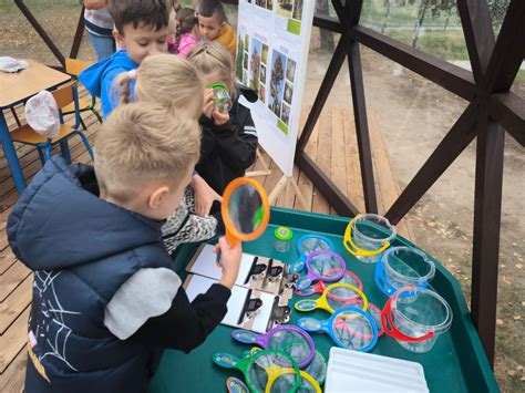 Vaikai tiria augalus lauko edukacinėje erdvėje