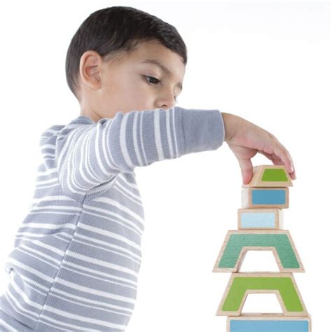 vaikas, dėliojantis spalvingas kaladėles