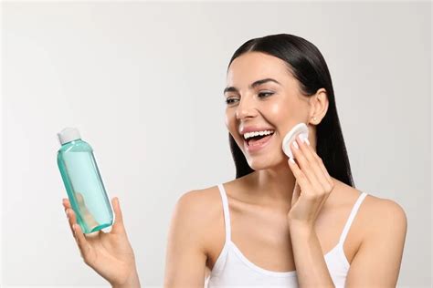 woman applying toner to face with hands