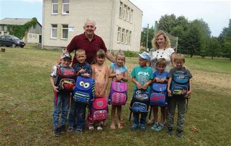 vaikai su kuprinėmis, mojuojantys atsisveikinant